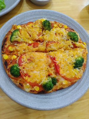 pizza with vegan cheese and vegetables at Mr. Khang Vegan Deli in Nha Trang