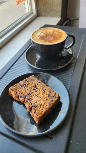 Oat latte and vegan chocolate pumpkin loaf at Krave Coffee in Toronto