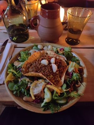 Tasty lentil stew served with spelt and a large salad with a lot of ingredients. at Olde Hansa in Tallinn