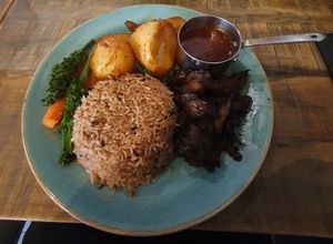 Vegan Sunday Roast - Jerk Mushroom (Ask your server for todays flavour) seasonal veg, garlic roast potatoes, rice & peas, fried plantain & our signature homemade veggie gravy. at Jerk Junction Wilmslow in Wilmslow