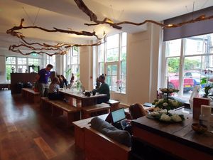 Communal seating in Triyoga studio reception room at Food & Mood in North West London