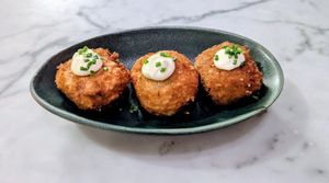 Chorizo Arancini: crumbed risotto fritters, aioli, chipotle ketchup at Mildreds - Victoria in South West London