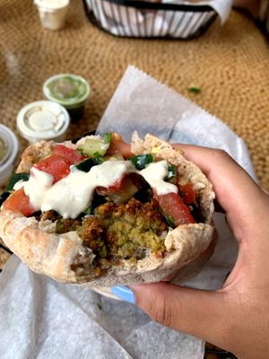 Falafel in a pita with cucumbers, tomatoes, and tahini sauce 🥙 at Nish Nush in New York City