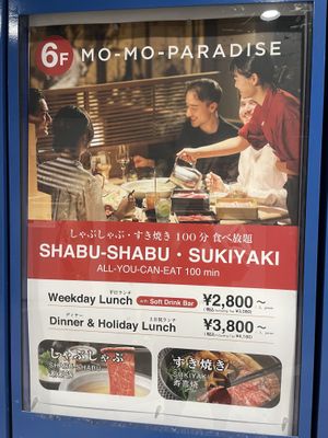 Sign at elevator advertising the restaurant upstairs   at Mo Mo's Paradise  in Tokyo