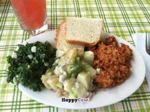 Yesterday's special was so good that we’re having it again! Raw kale slaw, dilly potato salad, and BBQ mock chicken. (Shown here with a refreshing glass of watermelon-mint infused water.) at Uncanny Kitchen in Abingdon