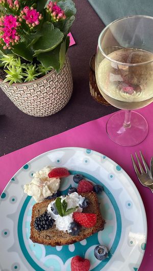 Homemade Banana bread full with fruits, seeds and nuts, topped of with vegan cream and accompanied by a soup of vegan vanilla-ice cream at CHALAZA in Valkenburg