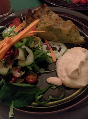 Vegan quiche with hummus and salad at Quinoa in Barcelona