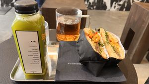 Ivy cold pressed juice & vegan bagel.  at Copains - Le Studio  in Paris