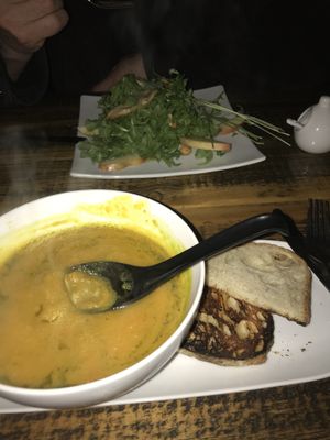 Butternut Squash Soup (Seasonal Dish) w/ Salad in background  at Revolution Kitchen in Burlington
