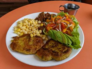 A la carte meal of seitan, corn, salad, and delicious patties (I think it was platano) at Quinua in Quito