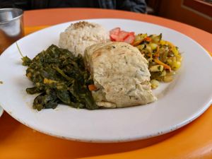 Rice, spinach, potato roll filled with seitan and veg, corn salad, picked radish. Yum. at Quinua in Quito