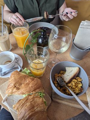 Pancakes, ham & cheese croissant, mexico scrambled tofu, white wine and fresh orange juice at GAL Cafe in Lisbon