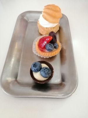 Profiterole, mini fruit tart and blue berry white and black chocolate. at Ratatouille in Turin