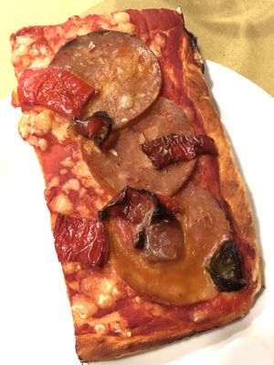 Pizza with vegan pepperoni, bell peppers, and vegan mozzarella  at Ratatouille in Turin