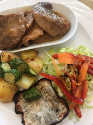 Lemon flavoured seitan cutlets, roast potatoes, and salad  at Ratatouille in Turin