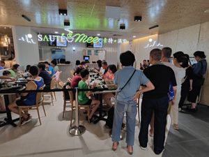 cafe front with people queuing for seats during dinner peak hour at Saute & Mee in Northeast Singapore