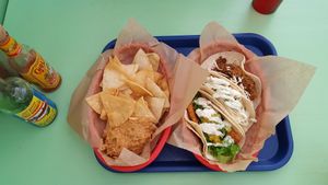 Tortilla chips with pinto dip, Crispy fried tofu, Tiki taco, Chorizo Seitan at Taco Party in Somerville