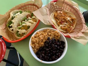 Fried Tofu and Chimichuri taco (top left), Fried plantain taco (top right) and beans/rice. at Taco Party in Somerville