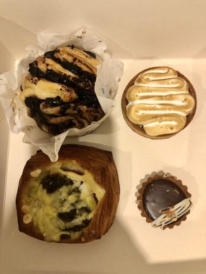 Clockwise from top left: chocolate brioche thing, lemon tart, a salted chocolate tart, and the same savoury tart as the other photo  at Maison des Lys Pâtisserie - Mt Eden in Auckland