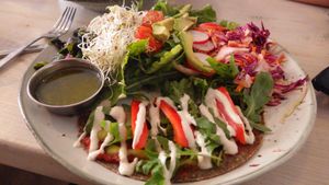 Raw pizza and salad with dressing at Matapoteket in Stockholm