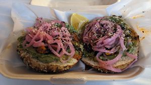 Pickled onions and an okay avocado mash on everything bagel at Bavarian Bagel Co in Leavenworth