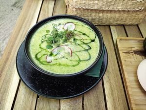 Broccoli and other vegetables cream soup with basil oil on top.   at Soul Kitchen in Sofia