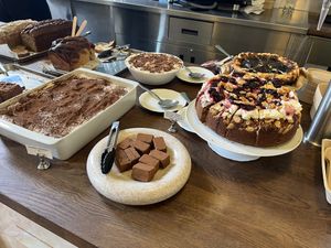 Desserts: tiramisu, cheesecake, banoffee, and almond cherry cake  at Café Petiole in London