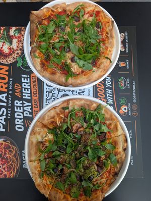 Bottom: pizza with eggplant, zucchini, rucola and olives 
Top: pizza with olives and rucola at PastaRun in Siracusa