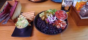 Guacamole with tortilla chips, and black bean rice bowl (black beans, corn, guacamole, red onion, red cabbage, salsa) at Batanga in York