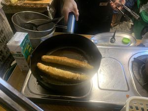 Sausages in the pan getting fried   at Lanna Square Vegan in Chiang Mai