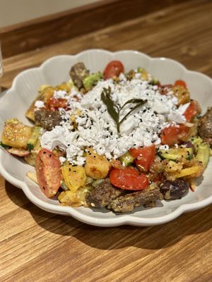 A delicious salad with vegan cheese  at Tiny Rebels in Crete
