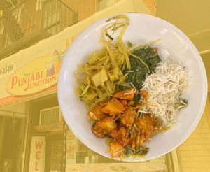 Vegan meal (plated at home) superposed over storefront at Punjabi Junction Of 87th in New York City