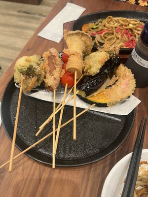Vegan Kushikatsu with plat based sauce. Yakisoba I’m the background.  at Pivot BASE Cafe & Bar ＠Dotonbori in Osaka