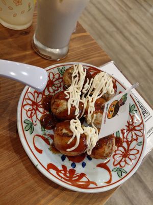 Standard takoyaki and ice coffee (background) at Pivot BASE Cafe & Bar ＠Dotonbori in Osaka