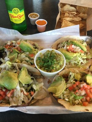 Rajas tacos (left), Vegetarian Crumble tacos (right), side of chips & guacamole. at El Camino Gourmet Tacos in Eagan