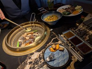 Cooking our own unseasoned food at the table at GUYSHI Bar + BBQ in Sheffield