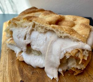 Pizza stuffed with ham and smoked cheese at Fermaggio Bistrot & Store in Rome