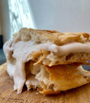 Pizza stuffed with ham and smoked cheese at Fermaggio Bistrot & Store in Rome