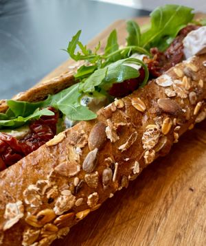 Cereals baguette with cashew brie, dried tomatoes and rocket at Fermaggio Bistrot & Store in Rome