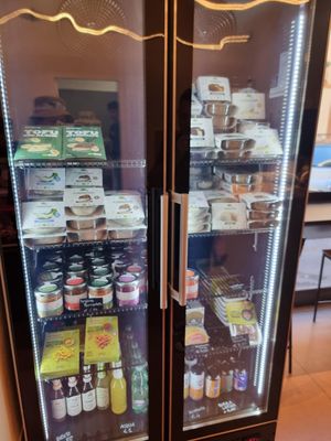 Fridge with cheezes and drinks at Fermaggio Bistrot & Store in Rome