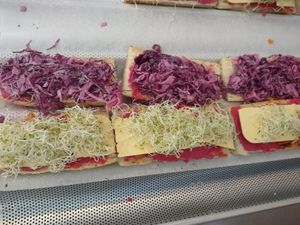 Eat the Rainbow sandwich: beet hummus, vegan smoked provolone, sprouts, purple cabbage slaw with horseradish mayo. at Darlings Grocery in La Pointe