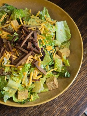 Vegan Caesar Salad with crispy tofu croutons, nutritional yeast, vegan cheddar and vegan bacon at Historia Cantina in Schomberg