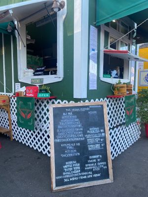 Picture of the menu and corner of cart. Not all menu items are on physical menu (ex: fried pickles).  at The Vegan Phoenix in Beaverton