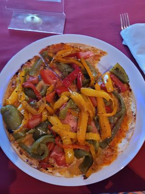 Vegan pizza, peppers tomato and nutritional yeast. Absolutely delicious at Cake's Cafe in Santa Fe