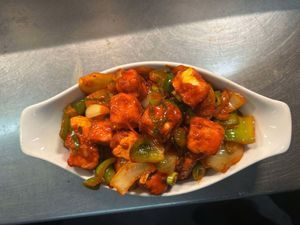 Crispy paneer cubes stir-fried with capsicum, onions & green chillies in a tangy, spicy soy sauce. Bold, flavorful, and perfect for spice lovers and vegetarians! at Shavan's Pakenham in Pakenham