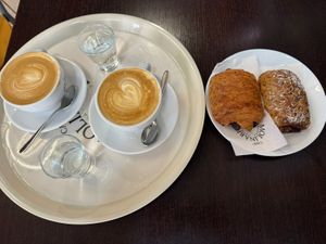 Soymilk cappuccino with pain au chocolat and filled pastry with blueberry jam  at Bar Chichibo in Bologna
