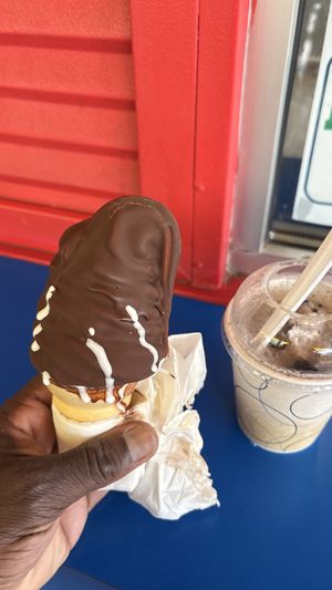 Oreo, cookie flurry, a.k.a. Oreo, cookie blizzard and vegan soft serve ice cream on a cone dipped in chocolate  at Dairy Twist Cafe in Wolverine Lake