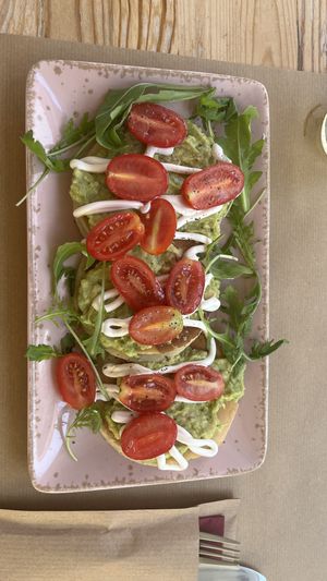 I had vegan pancakes topped with creamy avocado spread, fresh cherry tomatoes, arugula, and a touch of dressing. The pancakes were wonderfully fluffy. Definitely recommend!  at Naval Brunch  in Skiathos