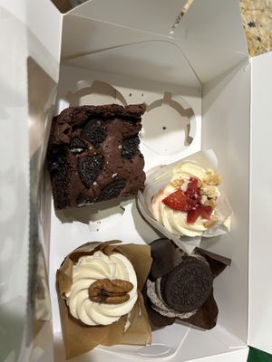 Oreo brownie, strawberries and cream cupcake, Oreo cupcake, and carrot cupcake.   at Sweet Haven Bakery in Citrus Heights