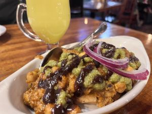 samosa chat appetizer without raita, and vegan golden milk in the background    at Mela in Asheville